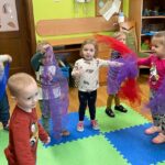 Dzieci tańczą z kolorowymi chustkami