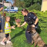 Dzieci wręczają wrzosy policjantom