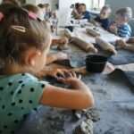 Przedszkolaki wykonują gliniane wytwory podczas zajęć ceramicznych