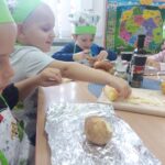 Chłopiec przyrządza ziemniaka z eko uprawy