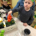 dzieci sadzą kwiatki