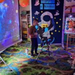 dzieci patrzą przez teleskop