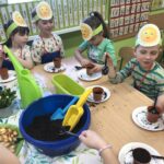 Dzieci wsypują ziemię do doniczek