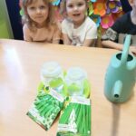 Dziewczynki z oddziału Żuczki przy stole przed sadzeniem nasion