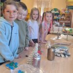 Dzieci oglądają przedmioty wykonane ze śmieci