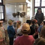 Dzieci oglądają średniowieczne gliniane naczynia