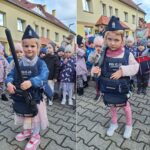 Dziewczynka w kamizelce z i pałką policyjną