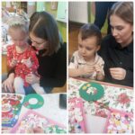 Dzieci z oddziału Żuczki przy stole podczas wykonywania światecznej dekoracji