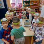 Przedszkolaki podczs zadania wyciągania śmieci z piasku