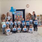 Zdjęcie grupowe- dzieci z pracami plastycznymi, niebieskie motyle