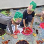 dzieci układają dary jesieni z produktów sensorycznych