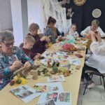 dzieci wraz z seniorami wykonują jesienne ludziki